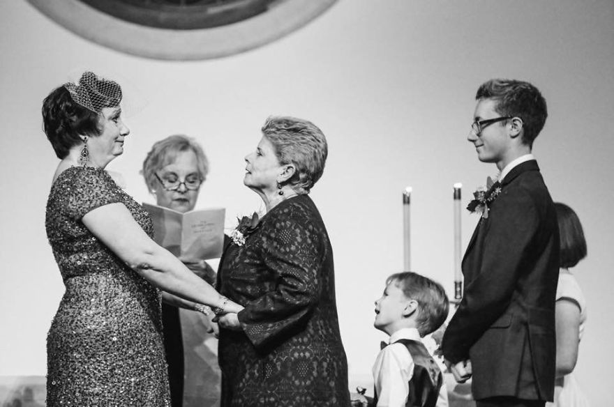 Two older woman holding hands and looking each other in the eyes 