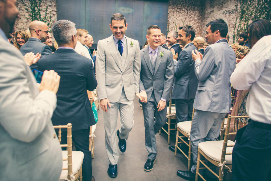 Two men holding hands and walking 