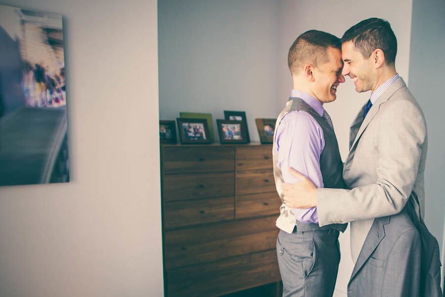 Two men hugging and looking at each others eyes 