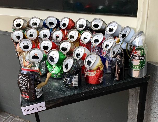 Crushed soda cans with open tops resembling surprised faces illustrating funny pareidolia in everyday objects.
