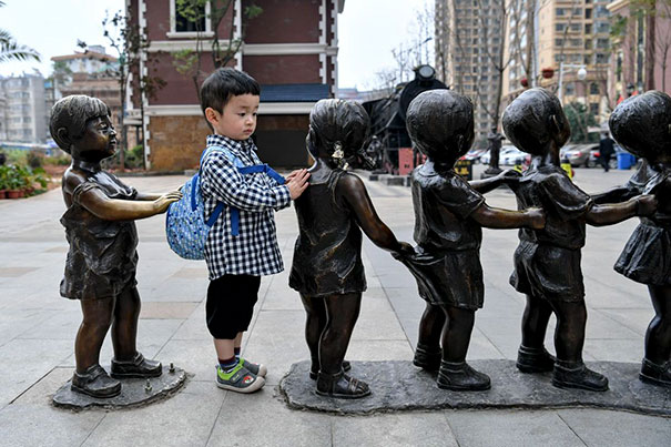 People Playing With Statues