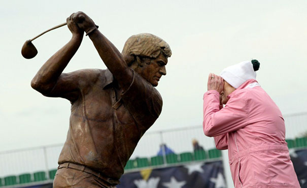 A Woman Looks Into The Eyes Of A Sculpture Of Jack Nicklaus