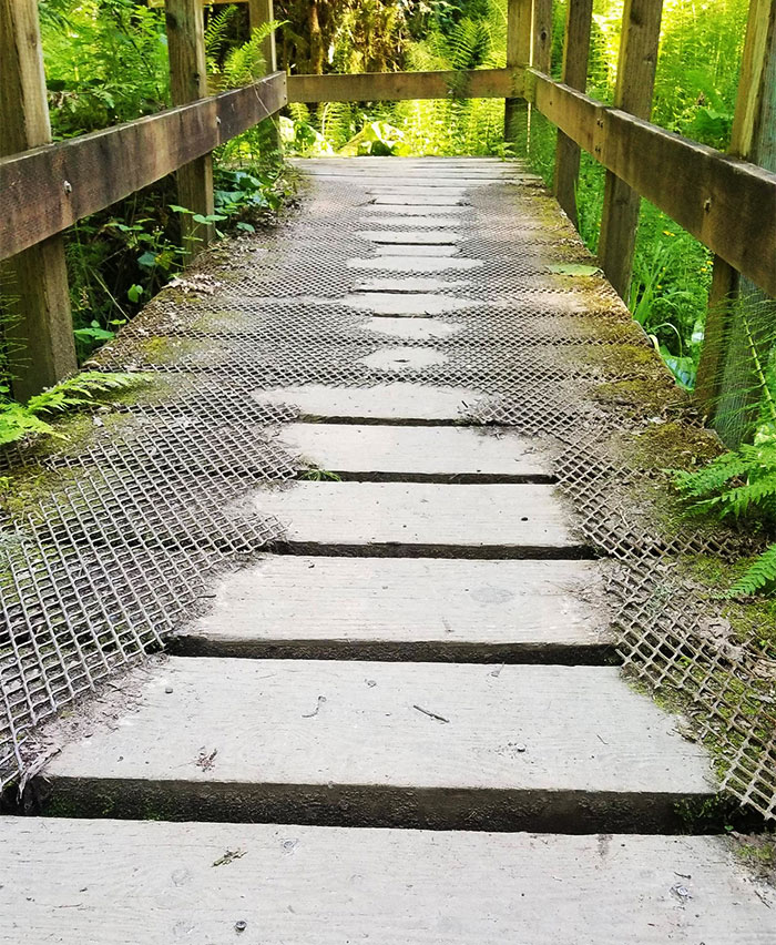 A Once Whole Metal Grate That Covered A Bridge