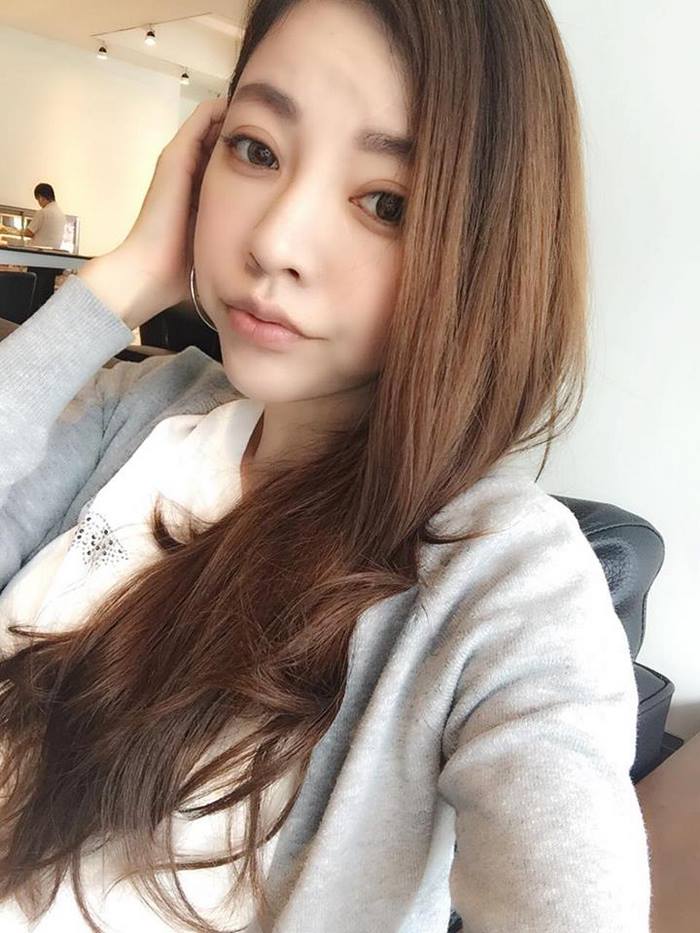 A youthful-looking 47-year-old woman with long brown hair, wearing a gray sweater, sharing age-defying secrets. A youthful-looking 47-year-old woman with long brown hair, wearing a gray sweater, sharing age-defying secrets.