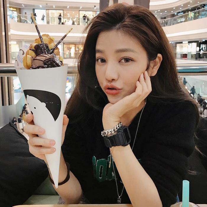 Youngest looking 47-year-old woman enjoying a dessert in a mall, showcasing her age-defying appearance. Youngest looking 47-year-old woman enjoying a dessert in a mall, showcasing her age-defying appearance.