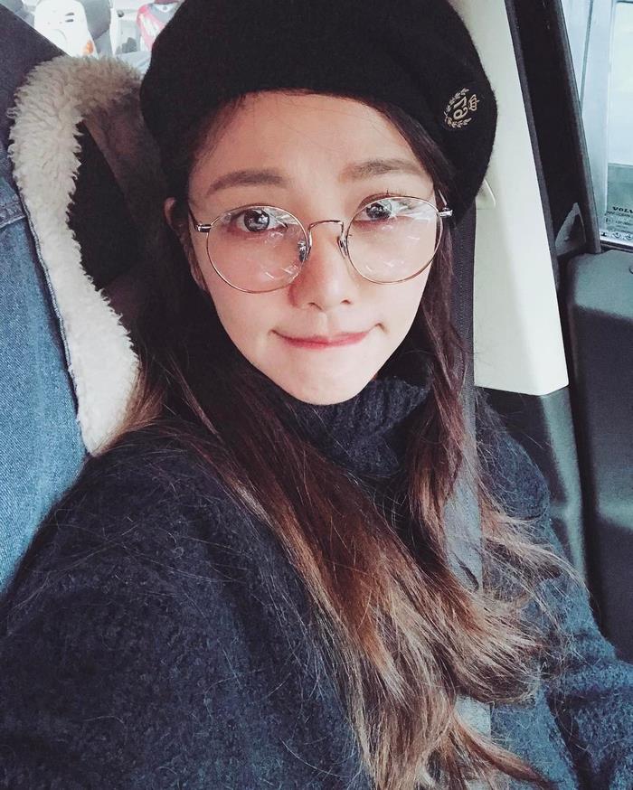 Youngest-looking 47-year-old woman wearing glasses and a beret, showcasing her age-defying appearance in a car. Youngest-looking 47-year-old woman wearing glasses and a beret, showcasing her age-defying appearance in a car.