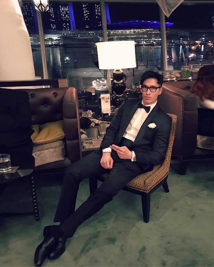 Chuando Tan wearing tuxedo, sitting in a chair, showcasing the body of a 20-year-old at age 59. Chuando Tan wearing tuxedo, sitting in a chair, showcasing the body of a 20-year-old at age 59.
