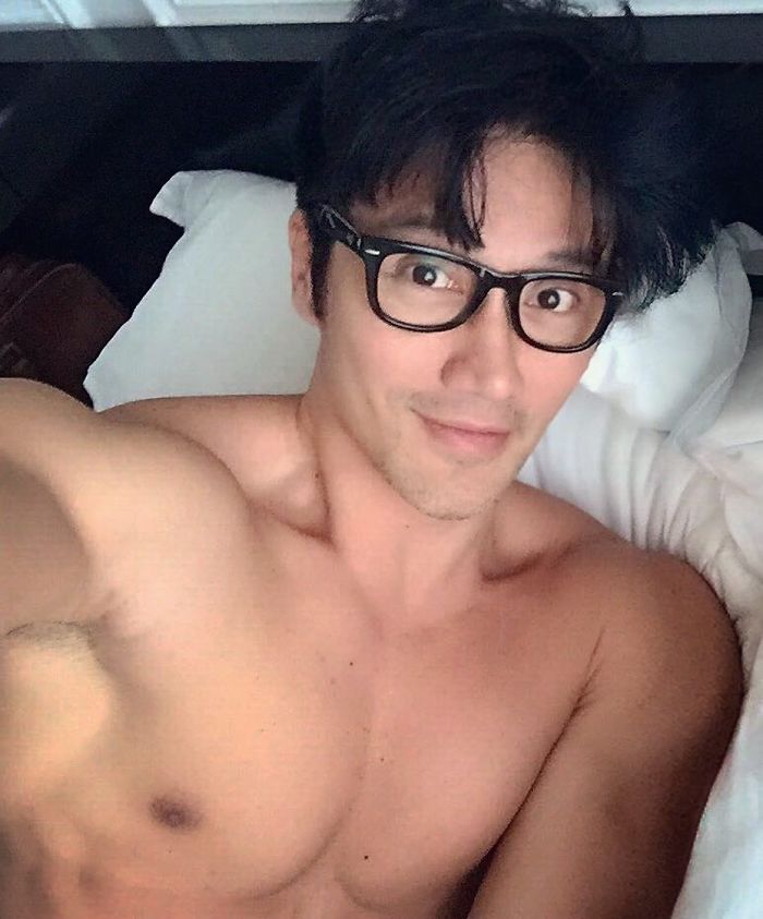 Chuando Tan taking a shirtless selfie in bed, showcasing the body of a 20-year-old at age 59. Chuando Tan taking a shirtless selfie in bed, showcasing the body of a 20-year-old at age 59.