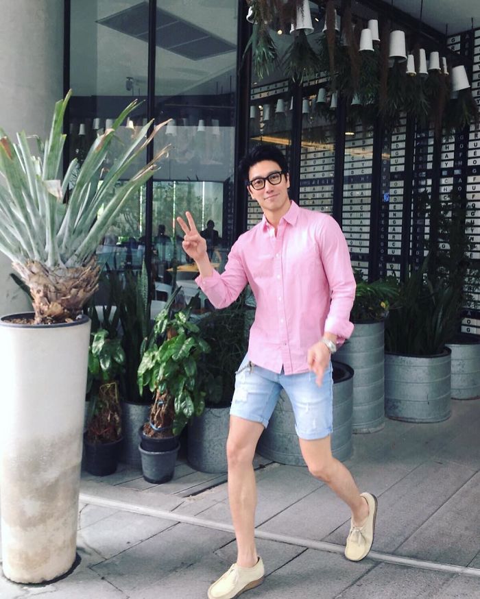Chuando Tan wearing a pink shirt and denim shorts, showcasing the body of a 20-year-old with youthful fitness. Chuando Tan wearing a pink shirt and denim shorts, showcasing the body of a 20-year-old with youthful fitness.