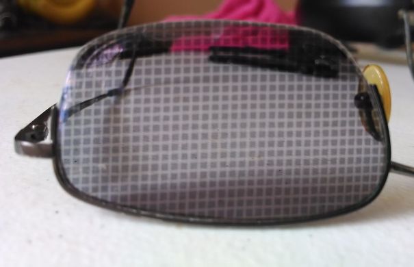 I Left My Transition-Lensed Glasses Next To A Window Screen And The Sun Left A Checkerboard Pattern On The Lens