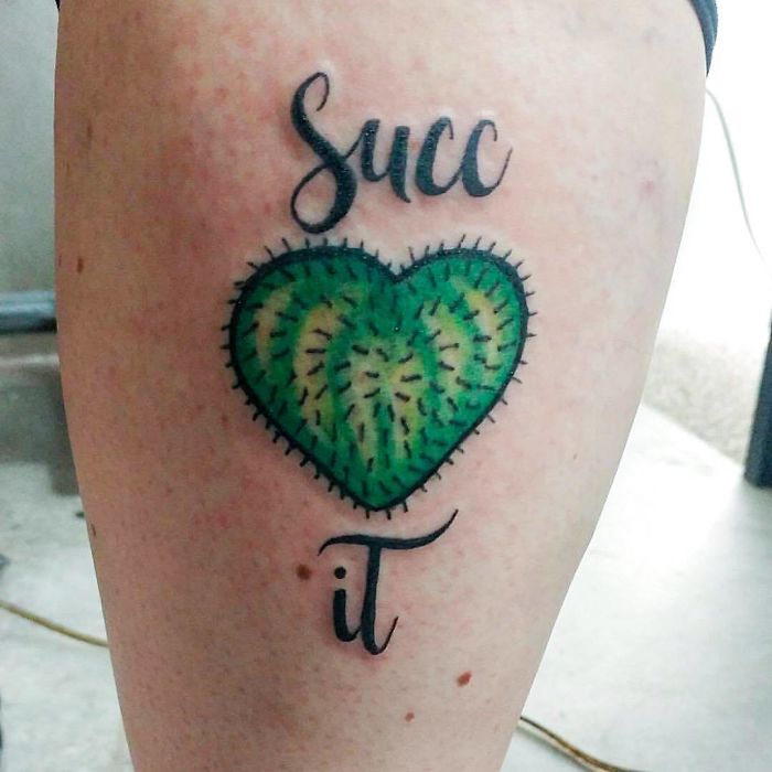 Heart-shaped succulent tattoo with text on skin.