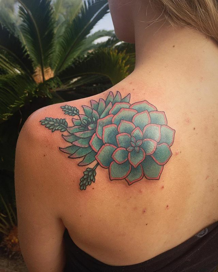 Succulent tattoo on shoulder in green and pink hues, showcasing detailed design, ideal for succulent enthusiasts.