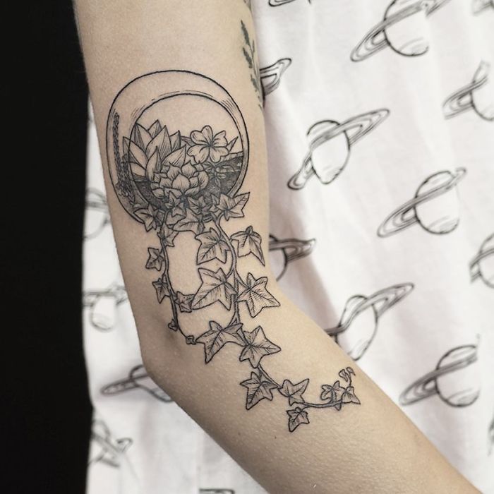 Succulent tattoo on arm with intricate vine details, showcasing creative succulent designs.