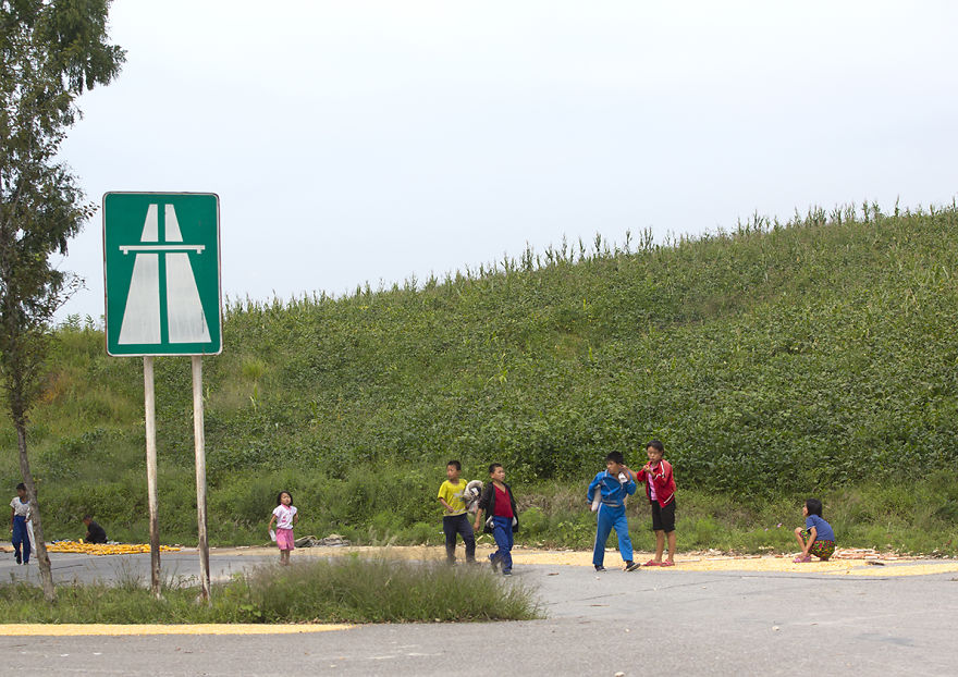 A Highway Junction Is So Rarely Used By Cars That Kids Can Even Dry Corn On The Road!