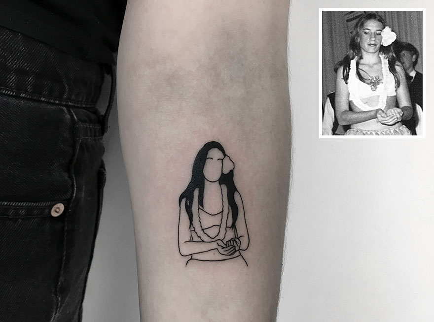 Tattoo of a woman with long hair on an arm, inspired by a black-and-white photo, emphasizing dedication to tattooing.