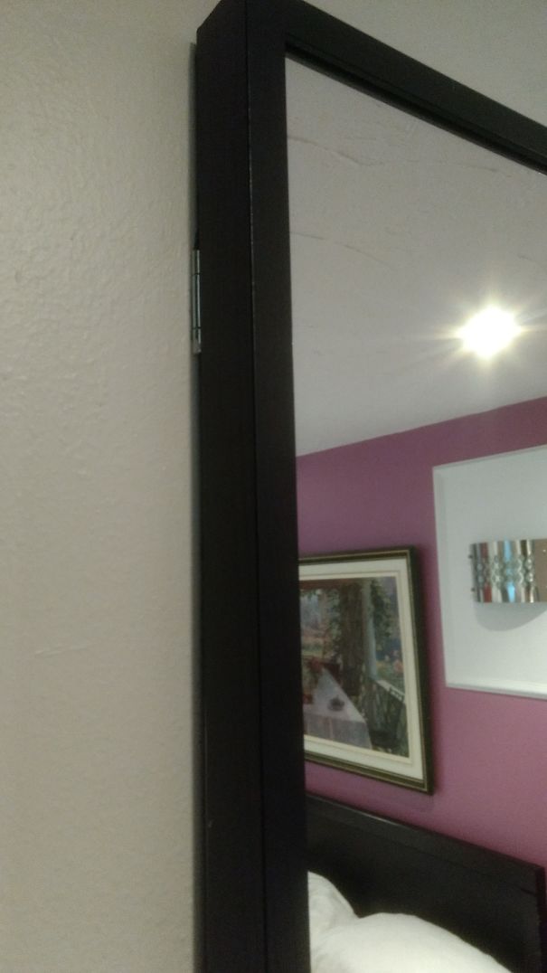 This Hinged Mirror In A Room That Was A "luxury" Upgrade Is Looking At My Bed.