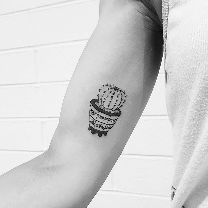 Succulent tattoo featuring a potted cactus on an arm, showcasing unique design ideas for succulent enthusiasts.