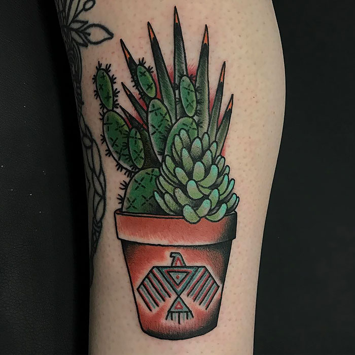 Succulent tattoo featuring a cactus and potted plant design on skin, showcasing vibrant green and brown hues.