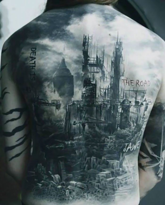 Back tattoo of dystopian architecture with text "Death is the Road to Awe."