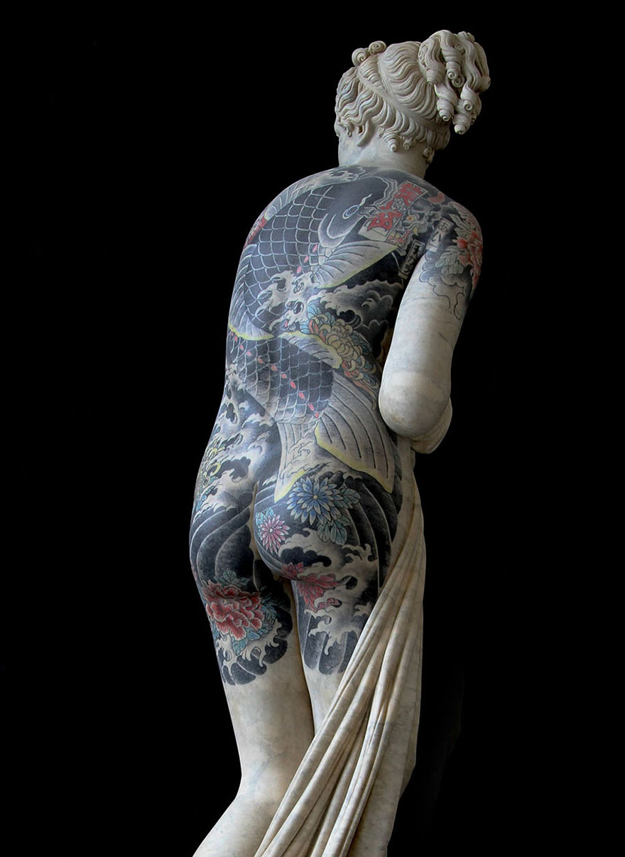 Classical sculpture with criminal tattoos by Italian artist, showcasing intricate body art. Classical sculpture with criminal tattoos by Italian artist, showcasing intricate body art.