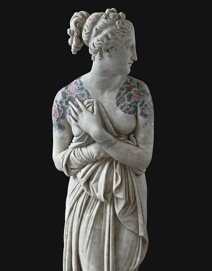 Classical sculpture with floral tattoos on shoulders by Italian artist, creating a bold, modern appearance. Classical sculpture with floral tattoos on shoulders by Italian artist, creating a bold, modern appearance.