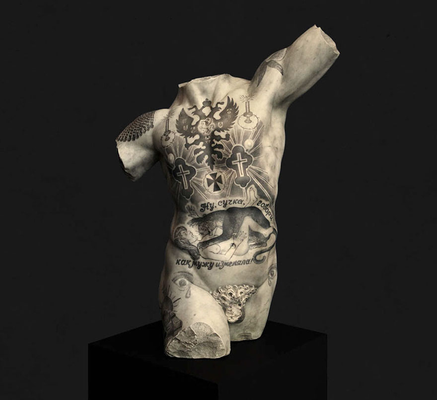Classical sculpture with criminal tattoos by Italian artist, on a black pedestal. Classical sculpture with criminal tattoos by Italian artist, on a black pedestal.
