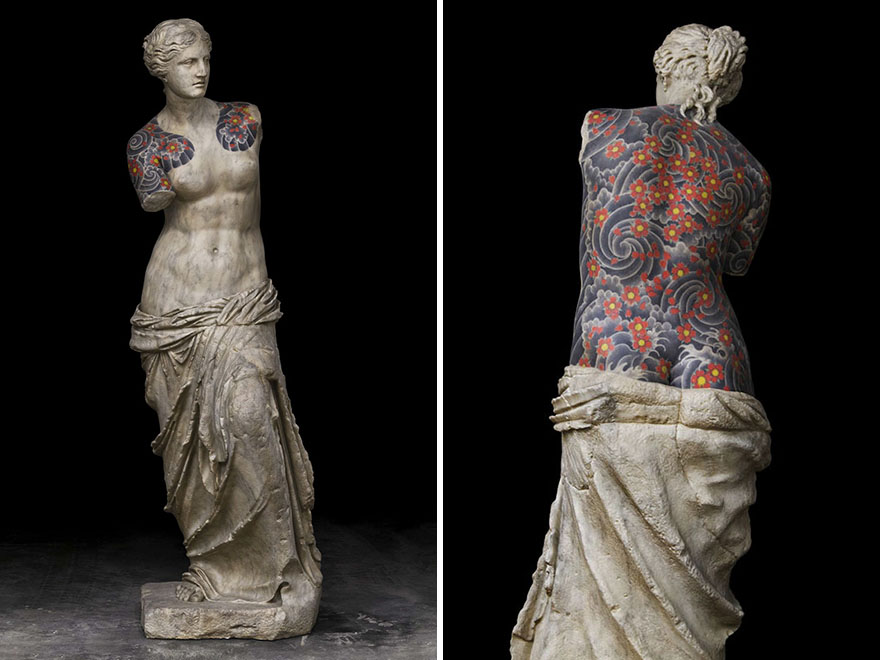 Classical sculpture with vibrant tattoos by Italian artist, showcasing a unique blend of art styles. Classical sculpture with vibrant tattoos by Italian artist, showcasing a unique blend of art styles.