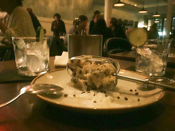 Cookie Batter Served On The Mixer Blade With A Cocktail Served In A Hip Flask