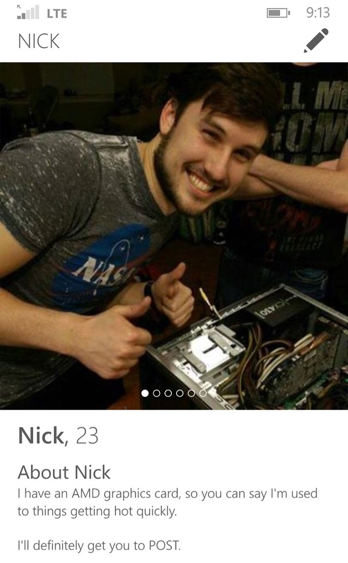 Man posing with thumbs up by computer, showcasing a funny Tinder profile with tech humor.