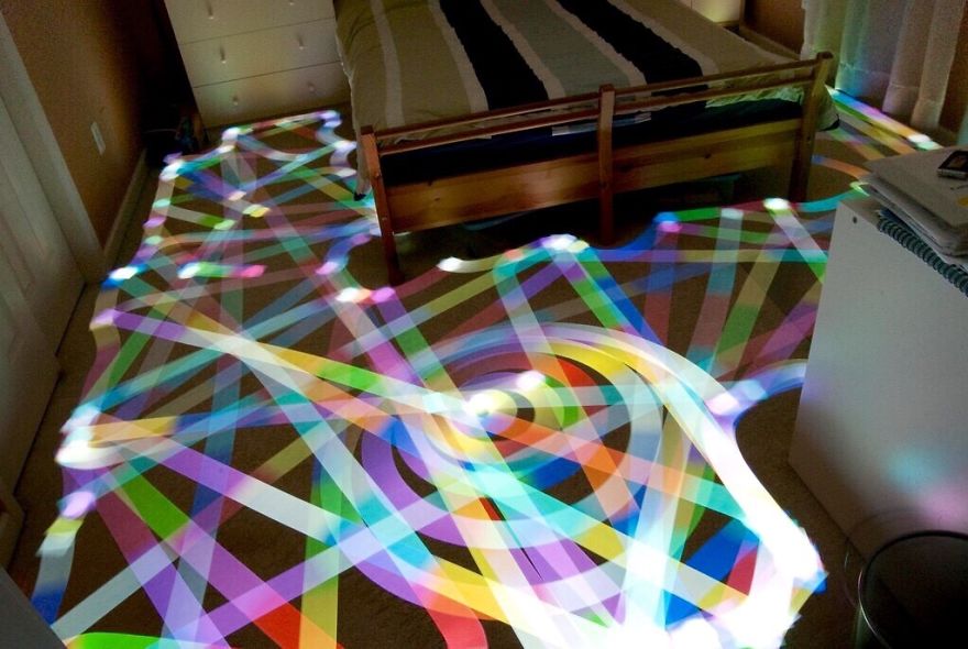 Long Exposure Of A Roomba Vacuum With Color-changing Light On Top