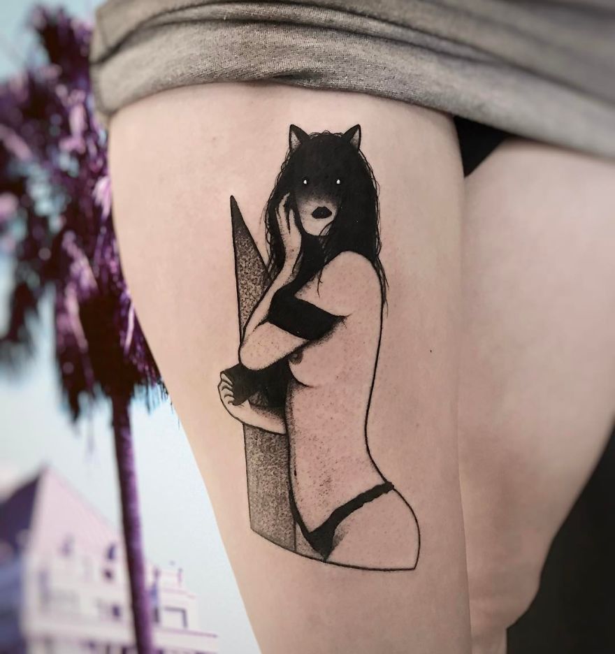 Faceless girl tattoo on a thigh, featuring a stylized female figure with wolf-like hair and minimalist design.