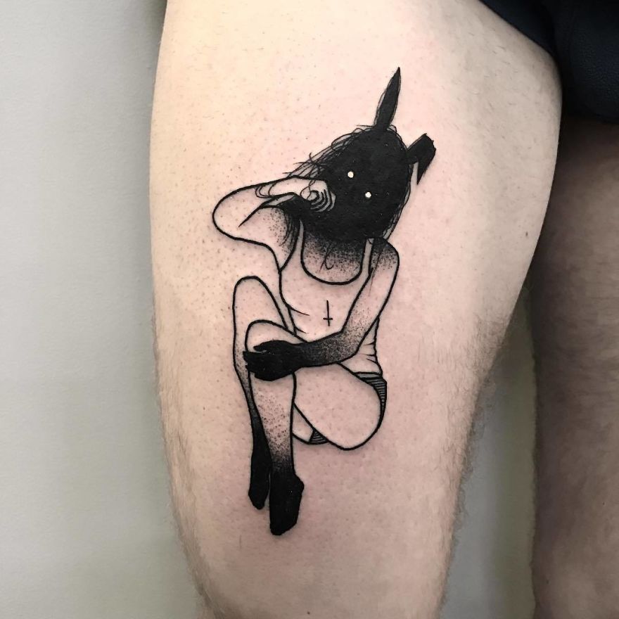 Faceless girl tattoo on thigh, featuring intricate black ink design in a seated pose, slightly erotic style.