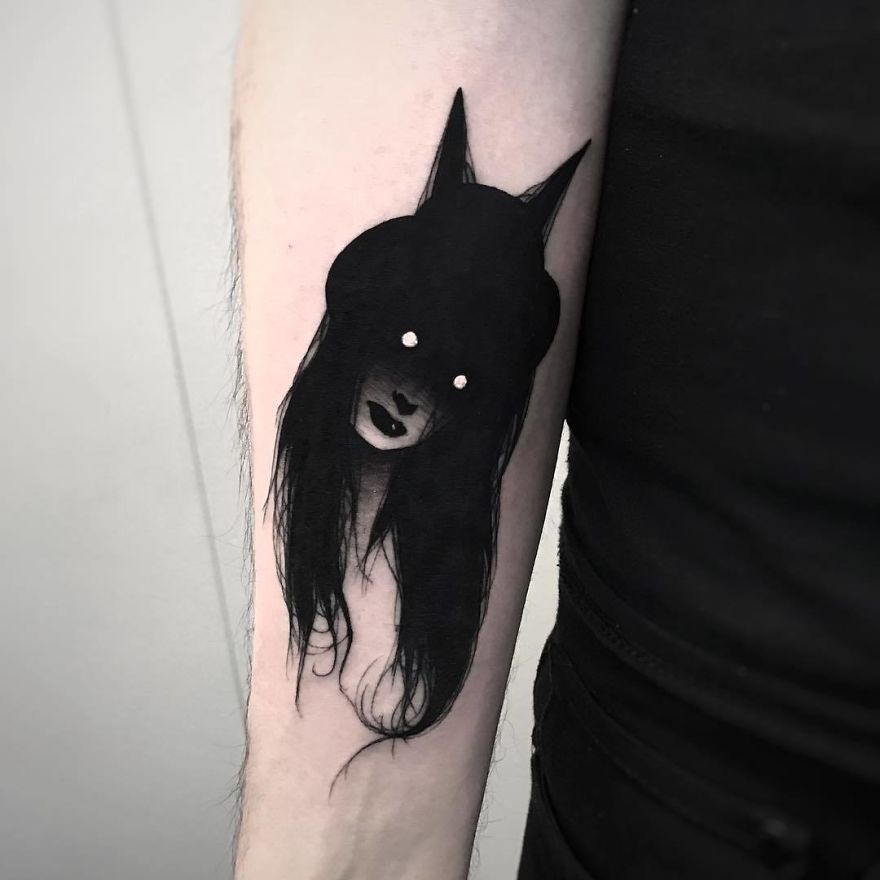 Tattoo of a faceless girl with long hair on an arm, in a slightly erotic and mysterious design.