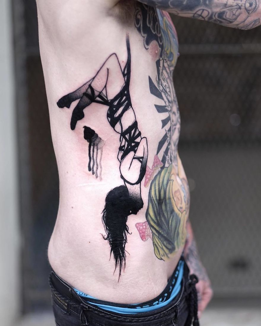 Slightly erotic tattoo of a faceless girl in a provocative pose on a person's side.