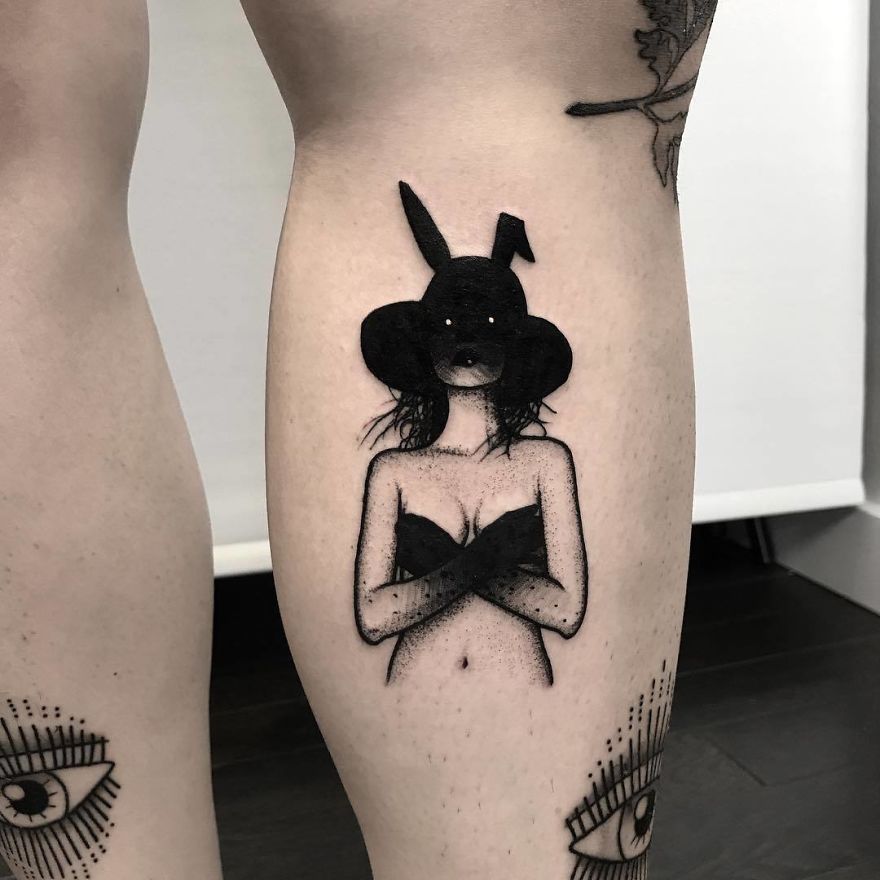 Tattoo of a faceless girl in a bunny hat and a bikini top on the back of a leg.