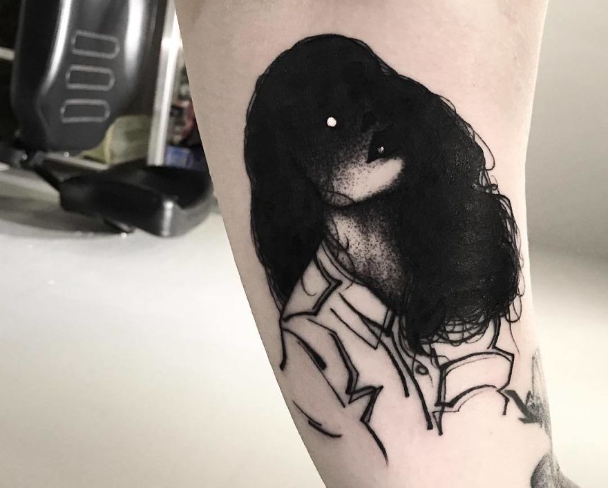 Faceless girl tattoo with dark hair and abstract lines on the arm.