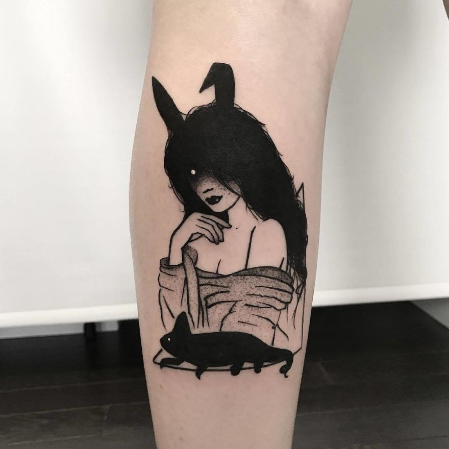 Tattoo of faceless girl with long hair and a cat, emphasizing a mysterious, slightly erotic design style.