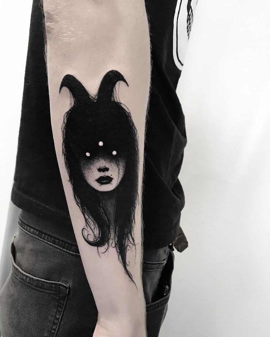 Tattoo of a faceless girl with long hair and abstract design on a person's arm.