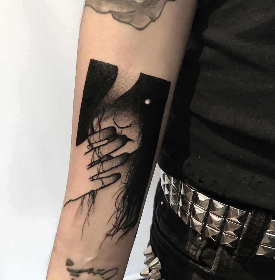 Faceless girl tattoo on an arm, featuring intricate line art and dark shading, with detailed fingernails and hair.