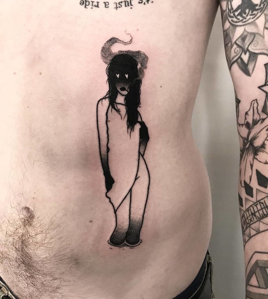 Tattoo of a faceless girl on a person's side, incorporating dark and abstract elements.