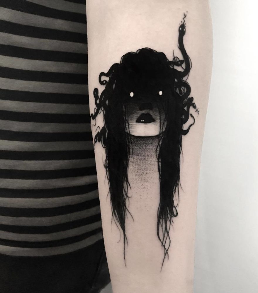 Faceless girl tattoo with dark hair and snakes on forearm, slightly erotic design in black ink.