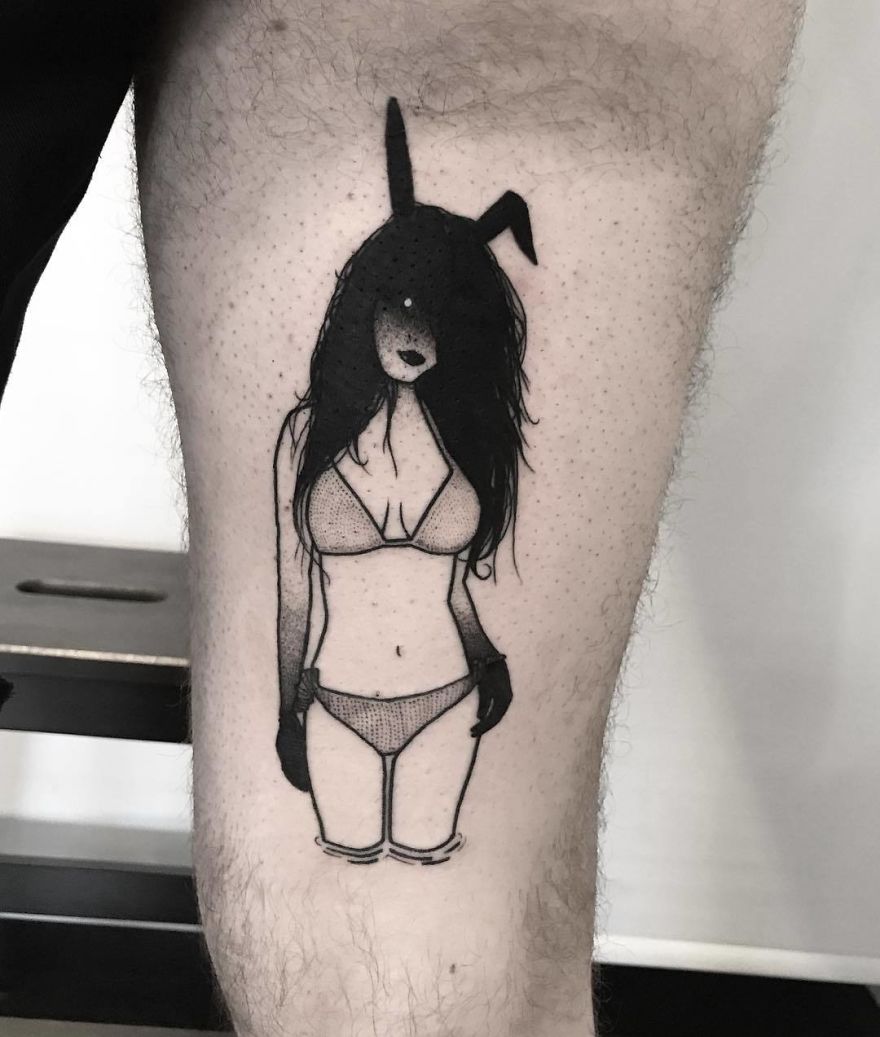 Tattoo of faceless girl in a bikini and bunny ears on a man's leg, blending seductive art with mystery.