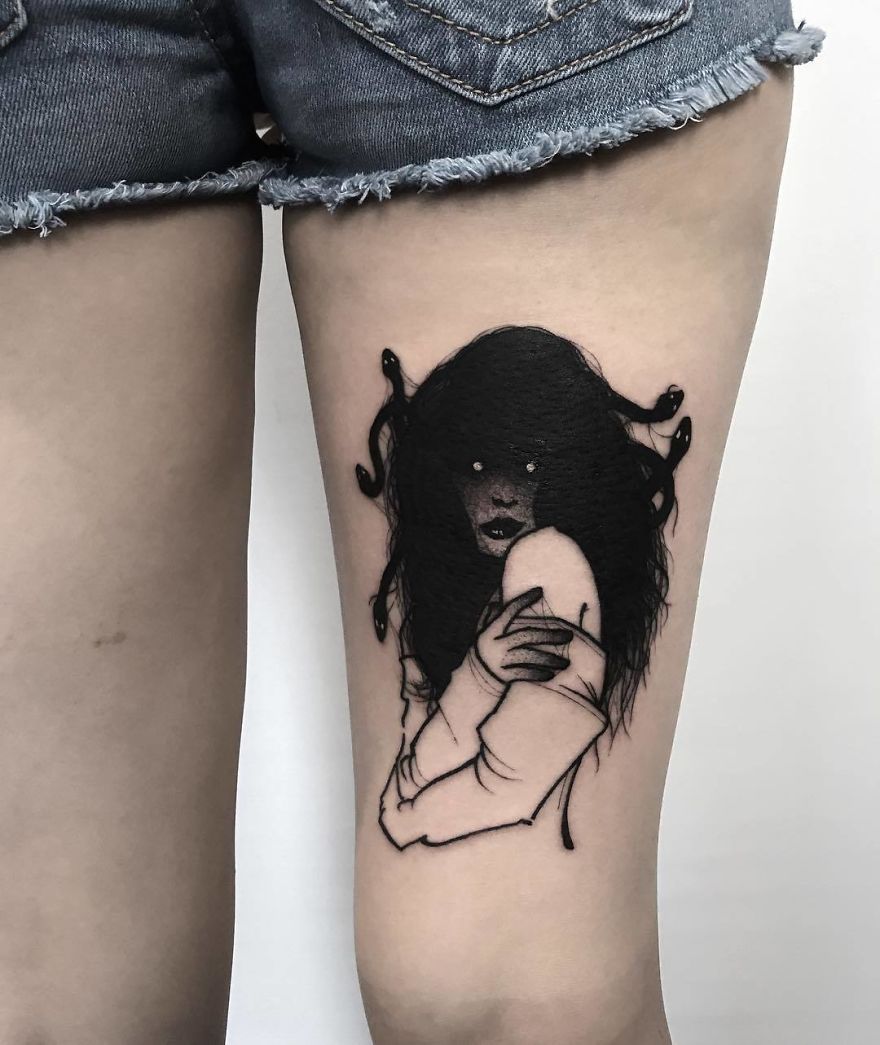 Faceless girl tattoo on thigh, with dark hair and mysterious aura.