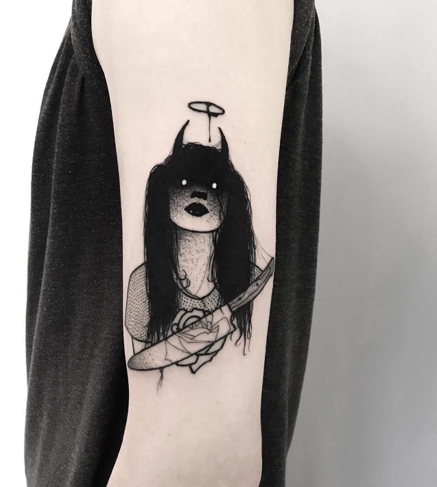 Tattoo of a faceless girl with dark hair and a halo, holding a rose and knife on an arm.