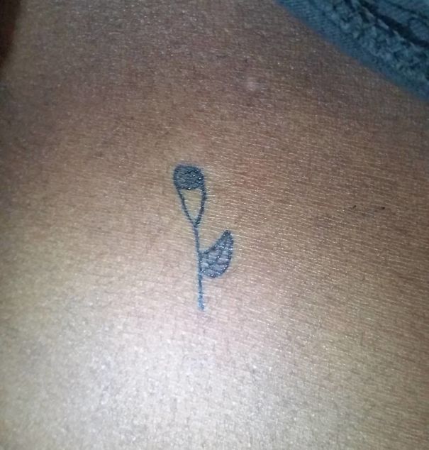 Simple flower tattoo by Brazilian artist known for unique drawing style.