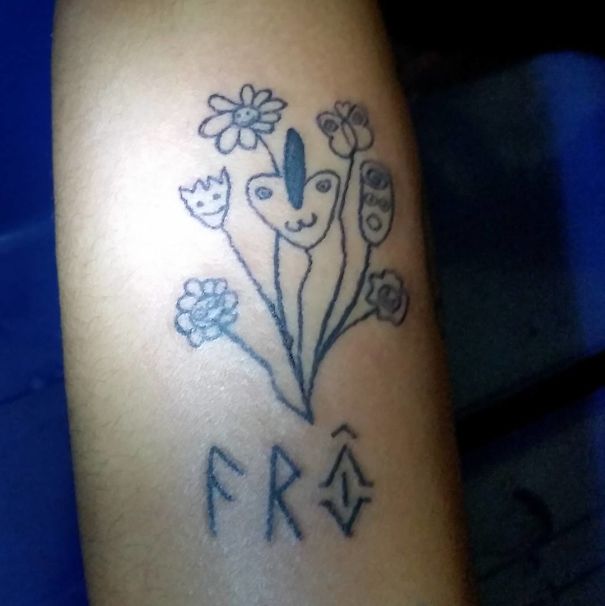 Unique tattoo art by Brazilian artist featuring simple floral and face designs with the text "FRA" below.