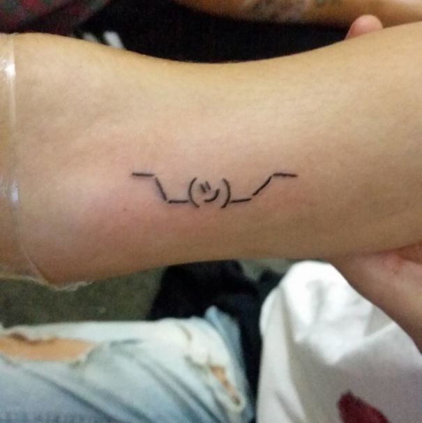Minimalist tattoo design on arm, created by Brazilian tattoo artist known for simplistic drawings.