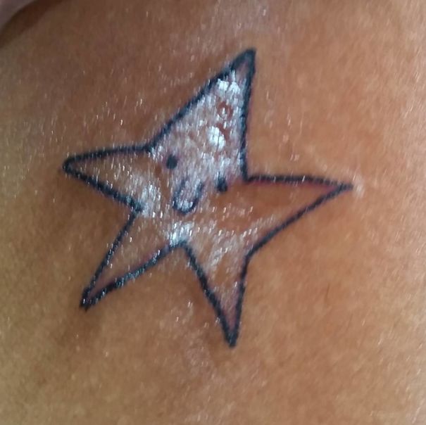A crude star tattoo by a Brazilian artist on skin, showcasing unique drawing style with visible ink outlines.