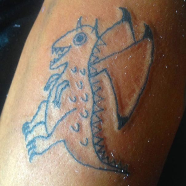 Amateur dragon tattoo by Brazilian artist drawn on skin.