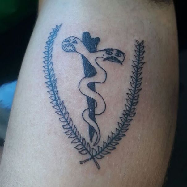 Unskilled Brazilian tattoo artist's quirky drawing of a snake wrapped around a stick with leaves on a person's skin.